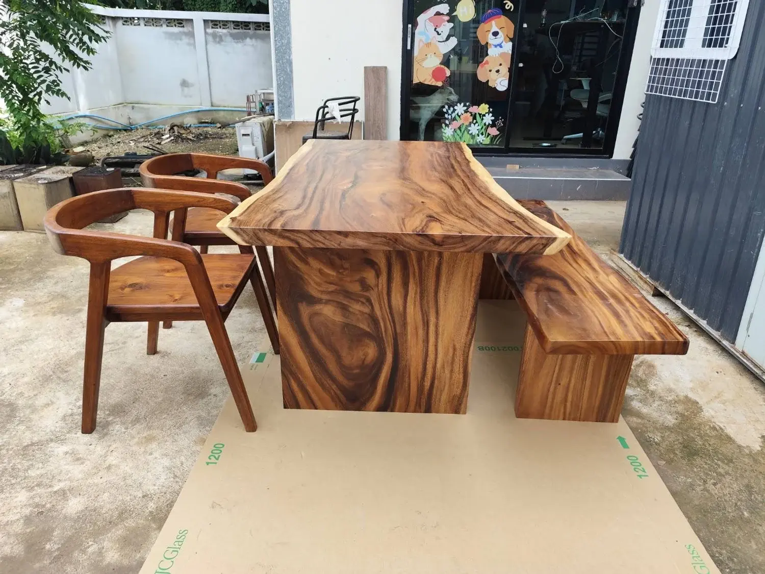 Original outdoor photo of the same wooden dining table and chairs
